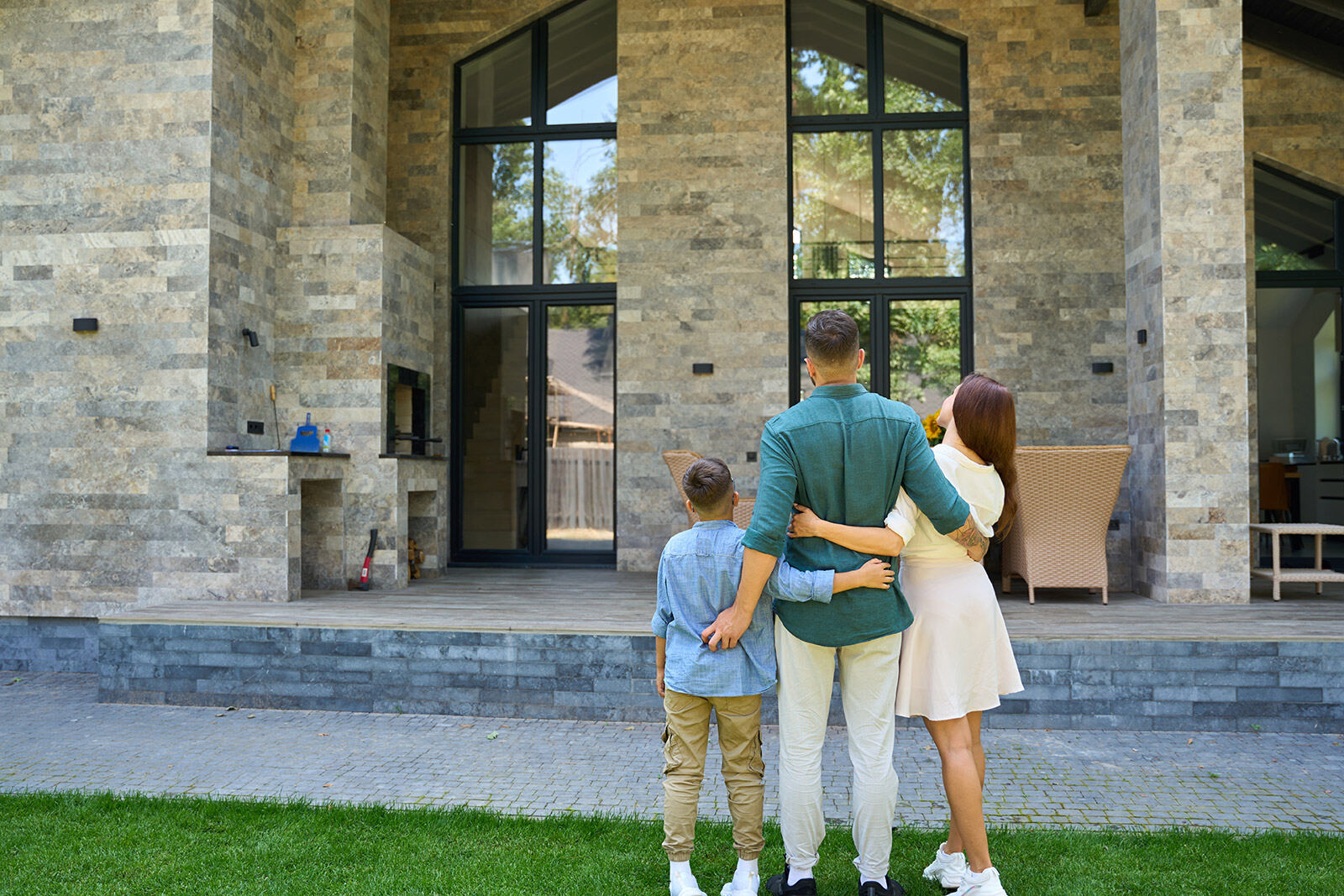 A family in front of their new custom home in North Texas